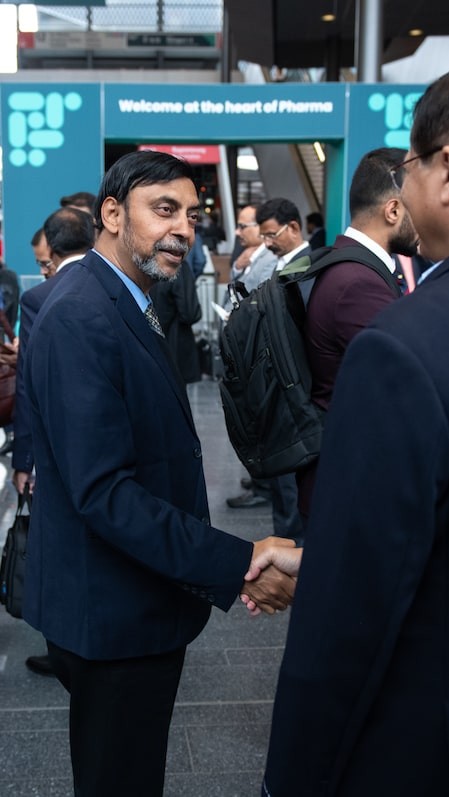 Two males in suits having a conversation